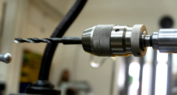 istock Drill holes with a drill on a lathe. 1284050336