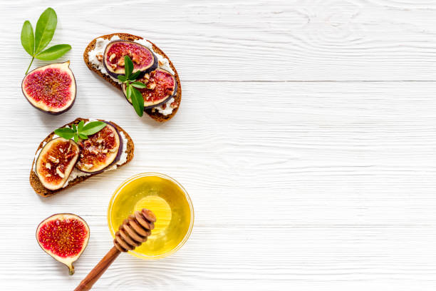istock Sandwiches with figs, cheese and honey on table 1284050730