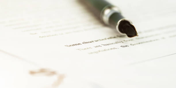 istock stylish fountain pen on bank agreement document macro 1284051921