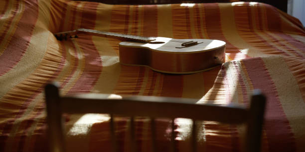 istock chair back against wooden guitar on bed covered with blanket 1284051925