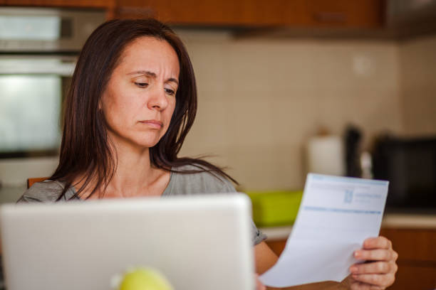 istock Worried woman going through her home finances in the kitchen. 1284052822