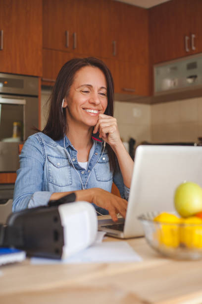 istock Happy woman having a video call over laptop while working at home. 1284052836