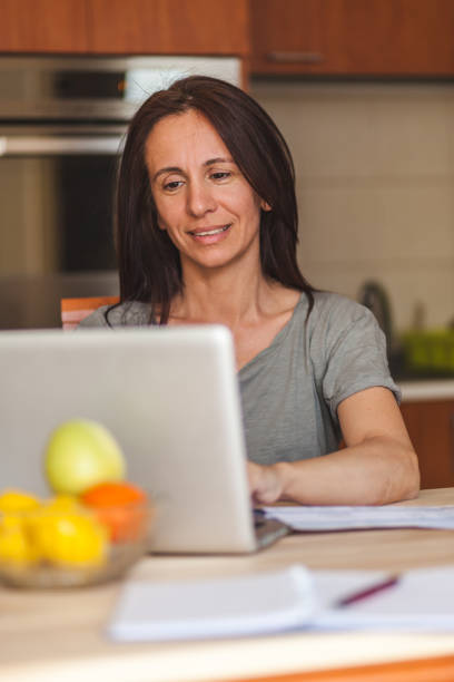 istock Happy woman working on a computer at home. 1284052838