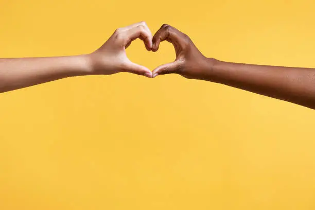 Photo of Diverse hands with love sign