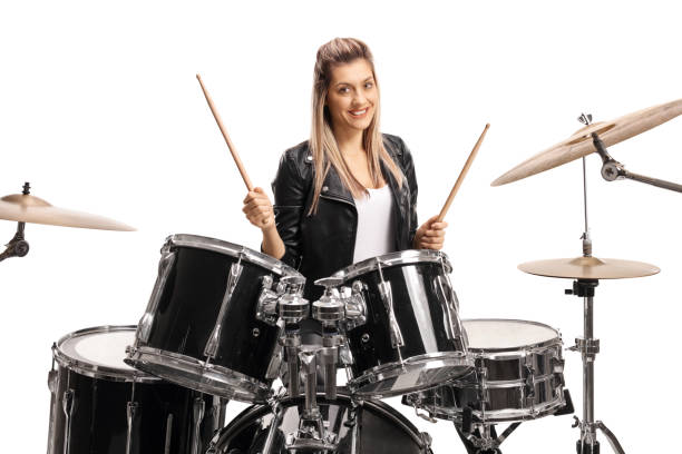 istock Female drummer smiling and holding a pair of drumsticks 1284053068