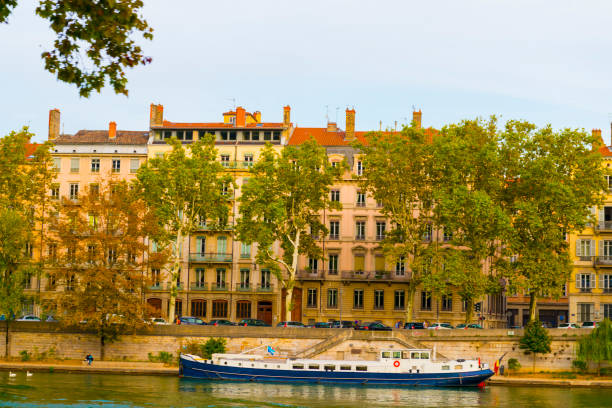 istock Boat in River with Houses in Lyon 1284053374