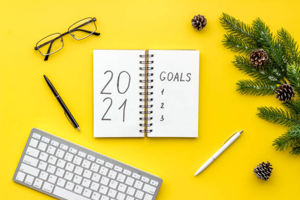 istock Inspiration concept - New Years goals written in notebook on a table, flat lay 1284054029