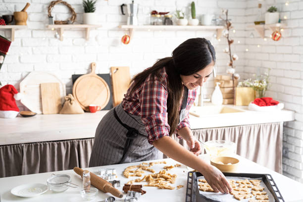 istock Young brunette woman baking cookies at the kitchen 1284055806