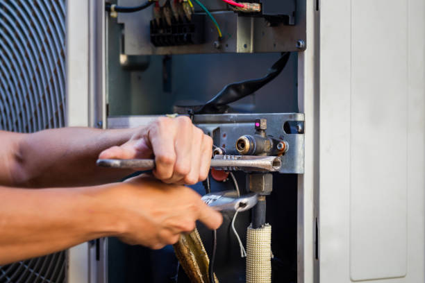 istock Technician man using a wrench fixing modern air conditioning system, Maintenance and repair concept 1284057983