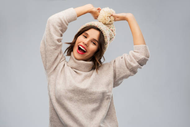 istock young woman in knitted winter hat and sweater 1284058005