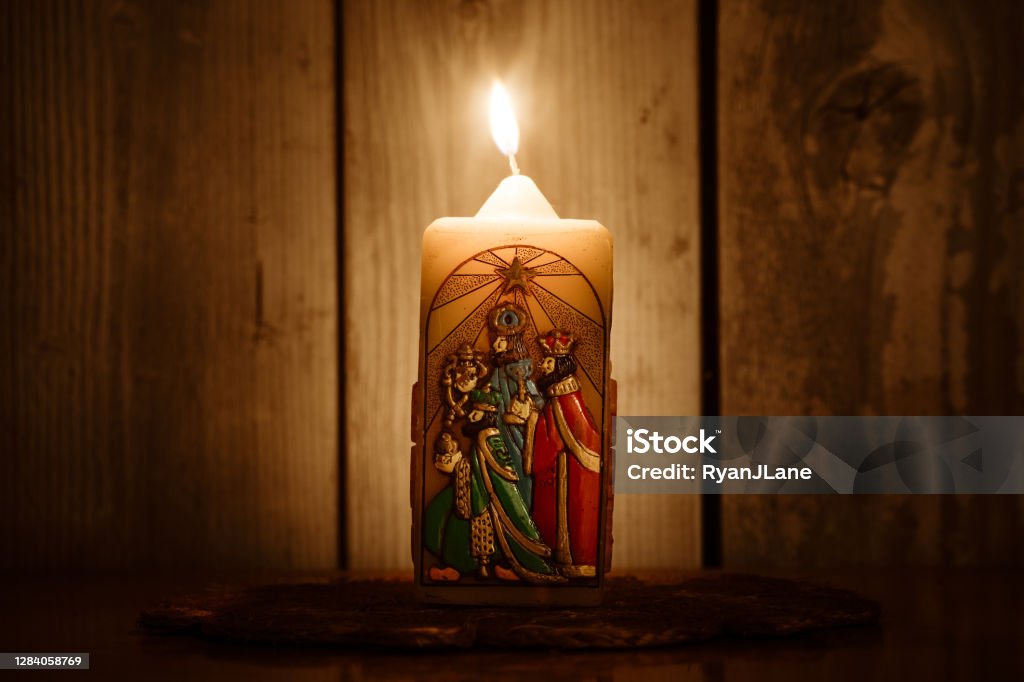 Candles for Epiphany Holiday Leading Up to Christmas An old candle with a likeness of three wise men from the Christmas story, coming to visit the Christ child.  Part of the celebration of Epiphany in early December. Epiphany - Religious Celebration Stock Photo