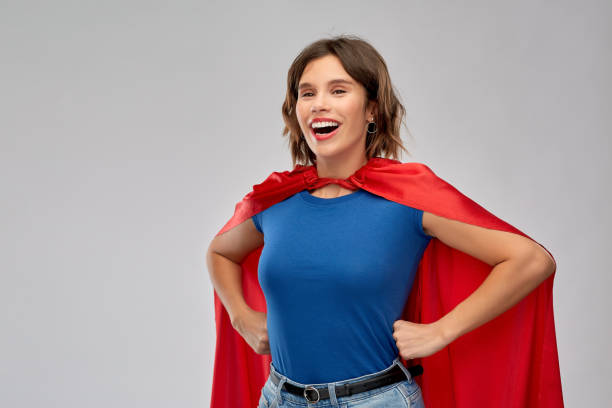 istock happy woman in red superhero cape 1284058816