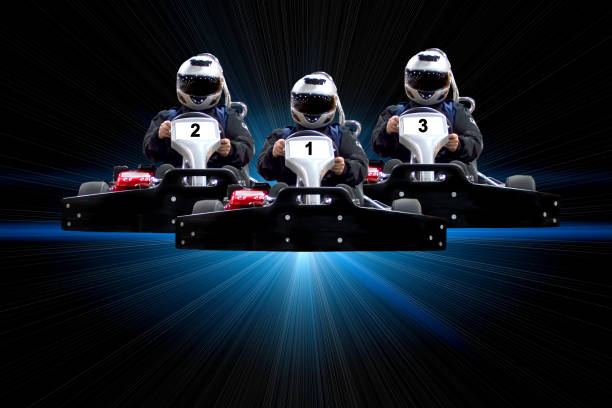 go kart indoor, cart racing fast, car where gokarting Go kart indoor, cart racing fast, car where gokarting, we speed racing, racers banner. Three riders Go kart speed rive indoor racing on a blue background with rays. Copy space. go carting stock pictures, royalty-free photos & images
