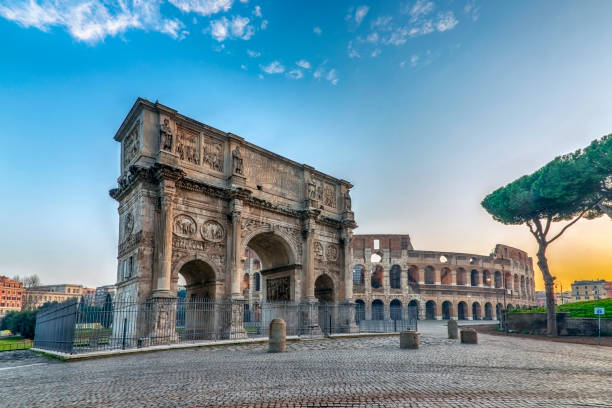 Ancient Colosseum and Monumental Arch of Constantine at early morning time in Rome, Italy.
