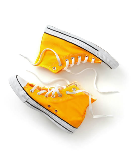 Canvas shoes on white Yellow canvas shoes on white canvas shoe photos stock pictures, royalty-free photos & images