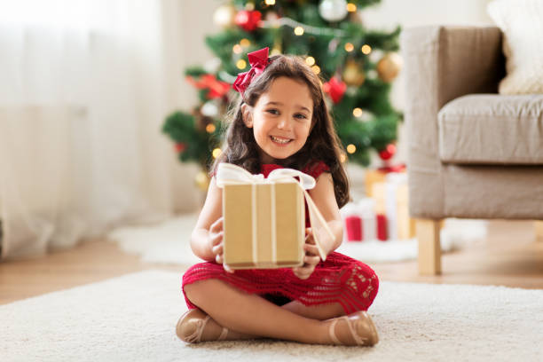 istock happy girl with christmas gift at home 1284062006