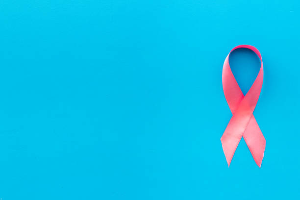 istock Pink ribbon breast cancer awareness. Top view 1284062063