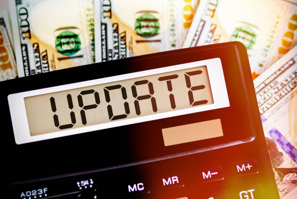 istock Calculator with text UPDATE on the dollars. Business, finance conceptual. 1284062129