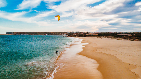 This is Kite Foiling at Praia do Martinhal, Sagres, Portugal\nKite surfing and Kite boarding as well as foiling are getting more and more popular besides surfing. Portugal is the place-to-be in Europe to be able to do it the whole year. Here are some amazing shots taken by a drone.
