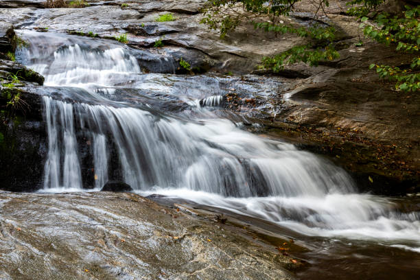 istock The waterfall flowing through the rocks in forest 1284063827