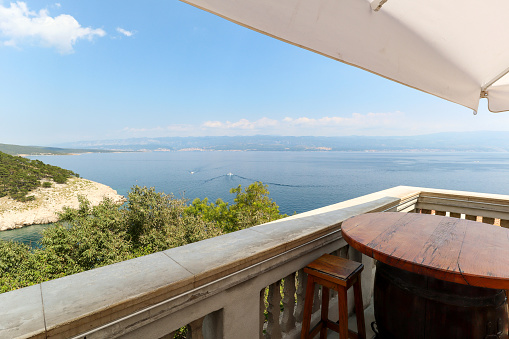 View from island Krk with rocky coastline and pine tree to dalmatian coast near Rijeka on Adriatic sea, Croatia Europe