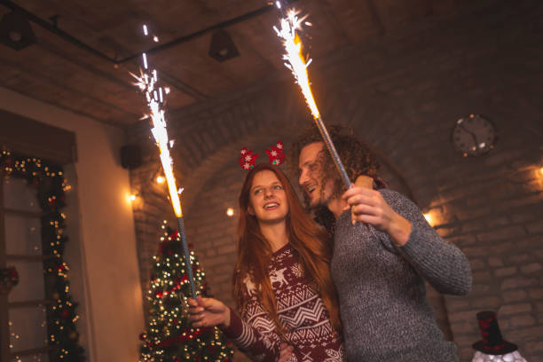istock Couple holding sparklers for Christmas Eve 1284063974