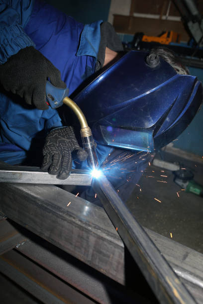 istock Electric arc welding. The worker welding two iron corners. 1284064856