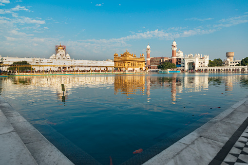 Amritsar India - September 16, 2012: A man baths in the sacred pool next to the Golden Temple. This is the holiest site of the Sikh religion, visited by millions of Sikh pilgrims each year.