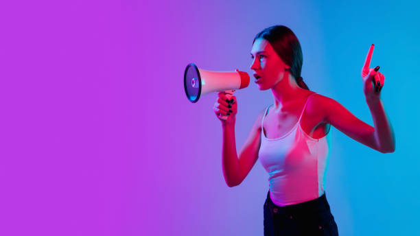 istock Young caucasian woman's portrait on gradient blue-purple studio background in neon light 1284065153
