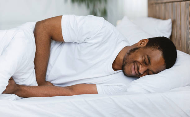 istock African American Man Having Stomachache Lying In Bed At Home 1284065198