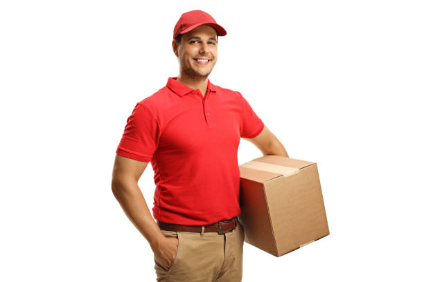 istock Male courier in a uniform holding  a box 1284065207