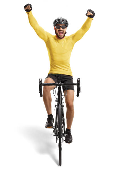 istock Male cyclist riding a road bicycle towards the camera and gesturing happiness 1284065252
