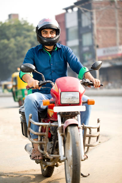istock Man riding motorcycle on city street 1284065295