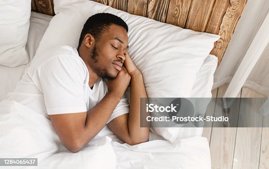 istock African American Man Sleeping Peacefully In Comfortable Bed At Home 1284065437