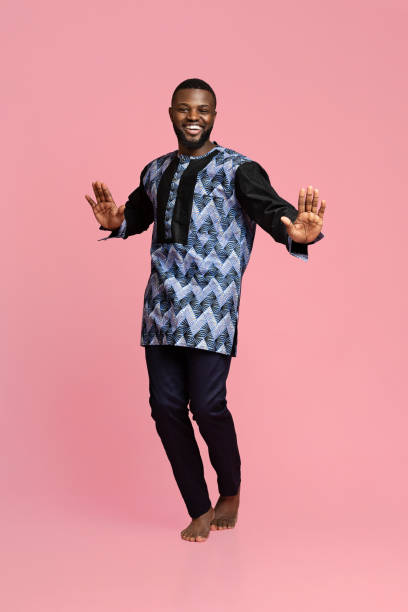 istock Bouncy african guy dancing over pink background 1284066460