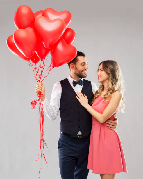 istock happy couple with red heart shaped balloons 1284068172
