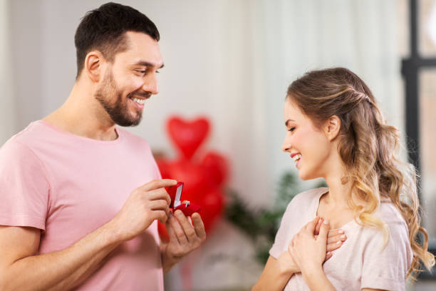 istock man giving woman engagement ring on valentines day 1284068222