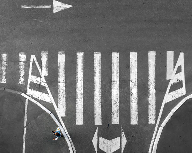 istock Pedestrian crossing on which people go. View from above 1284070769