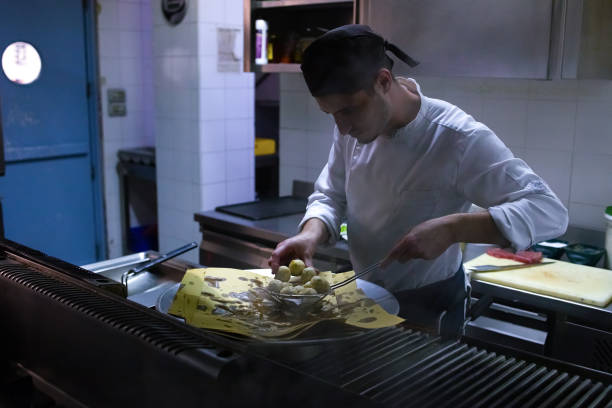 istock Young chef prepares a fry in the restaurant 1284070932