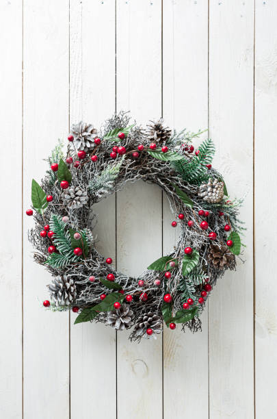 istock Christmas wreath on white wooden background - rustic home decoration 1284072307