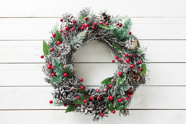 Christmas wreath on white wooden background - rustic home decoration