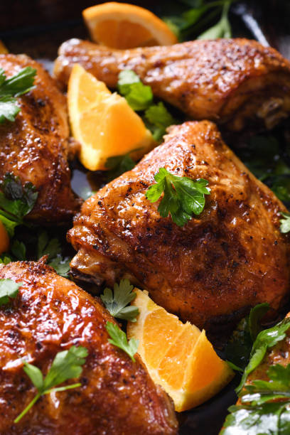 istock appetizing slices of baked chicken with crispy fried crust and oranges in a baking sheet 1284072436