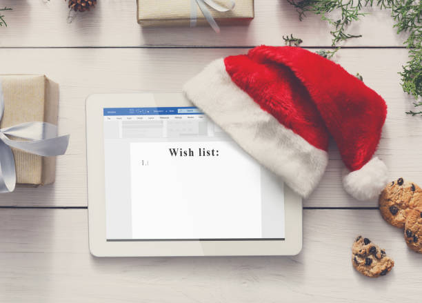 istock Electronic Wish List. Digital Tablet With Santa Hat, Creative Christmas Background 1284074434