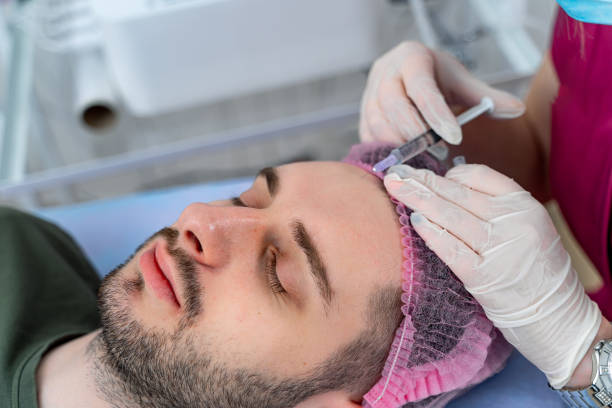 istock Procedure on the forehead. Man at cosmetologist. Mesotherapy, plasmolifting. Botox injections. Closeup. 1284074463