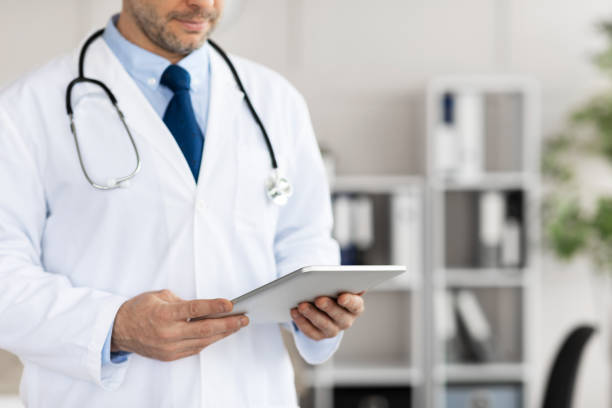 istock Close up of medical practitioner using digital tablet in clinic 1284074742