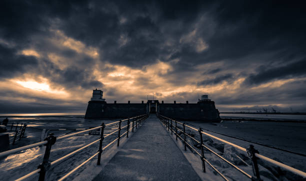 Fort Perch Rock military fortification at the mouth of the River Mersey near Liverpool, Wallasey, Wirral against a dramatic sky.