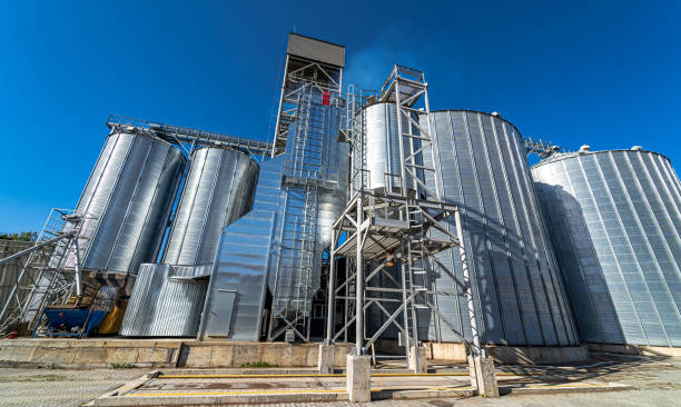 istock Metal grain elevator in agricultural zone. Harvested grain storage. 1284075941