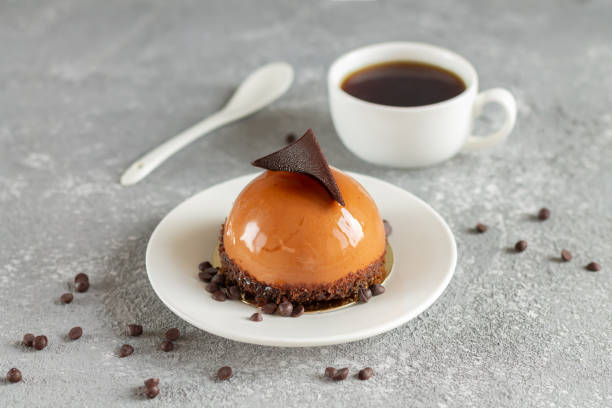 istock Chocolate mousse cake and cup of coffee on stone table 1284076239