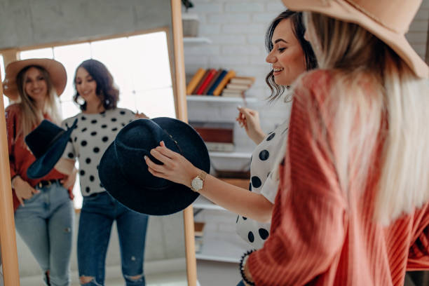 istock Two best friends playing with hat in front of mirror 1284076718