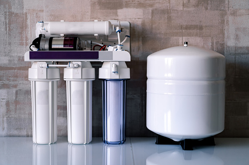 Reverse osmosis water purification system at home. Installed water purification filters. Clear water concept